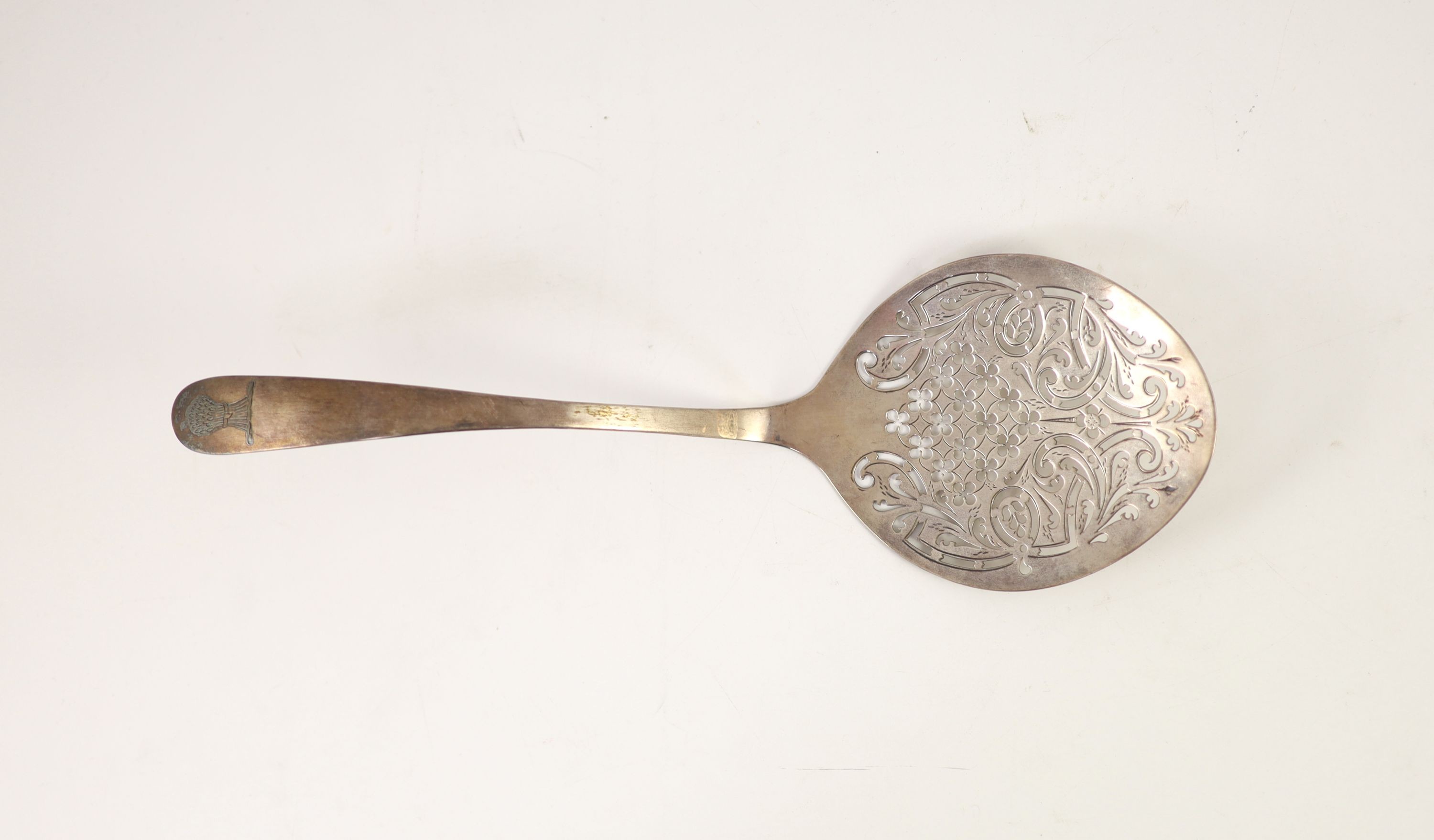 An 18th century Irish pierced silver fish serving ladle, maker W.T., marks rubbed, 30.2cm, 99 grams.